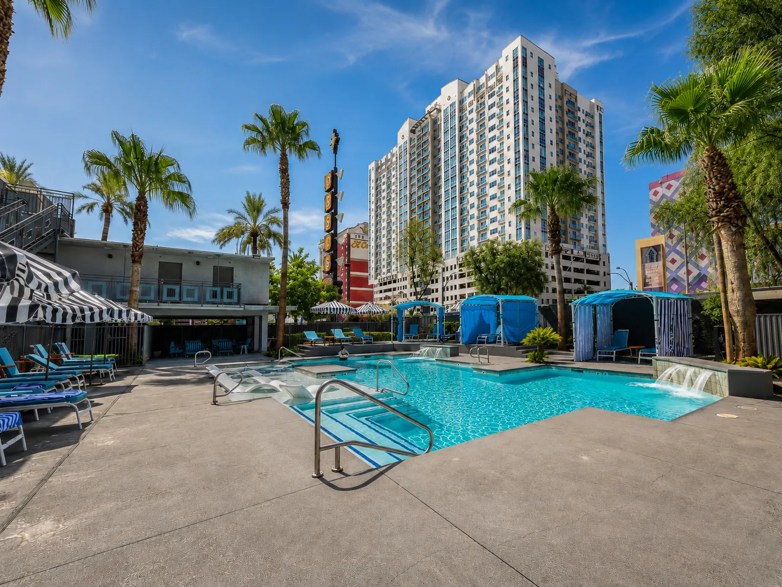 Oasis pool deck with palms and downtown towers