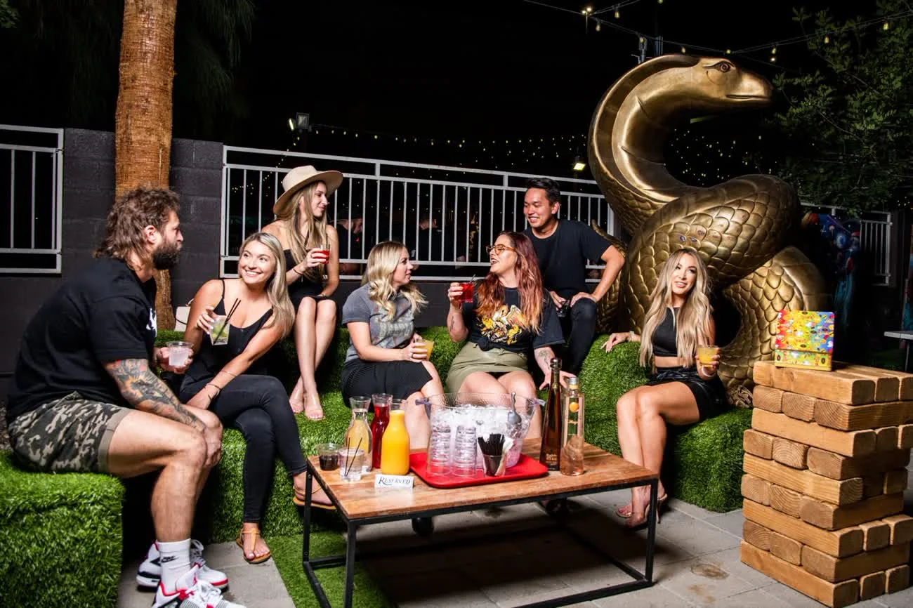 Friends in the Courtyard lounge by the gold snake